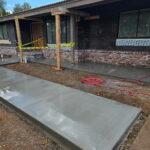 Citrus Bloom Landscape team pouring and finishing cement for a driveway or patio.